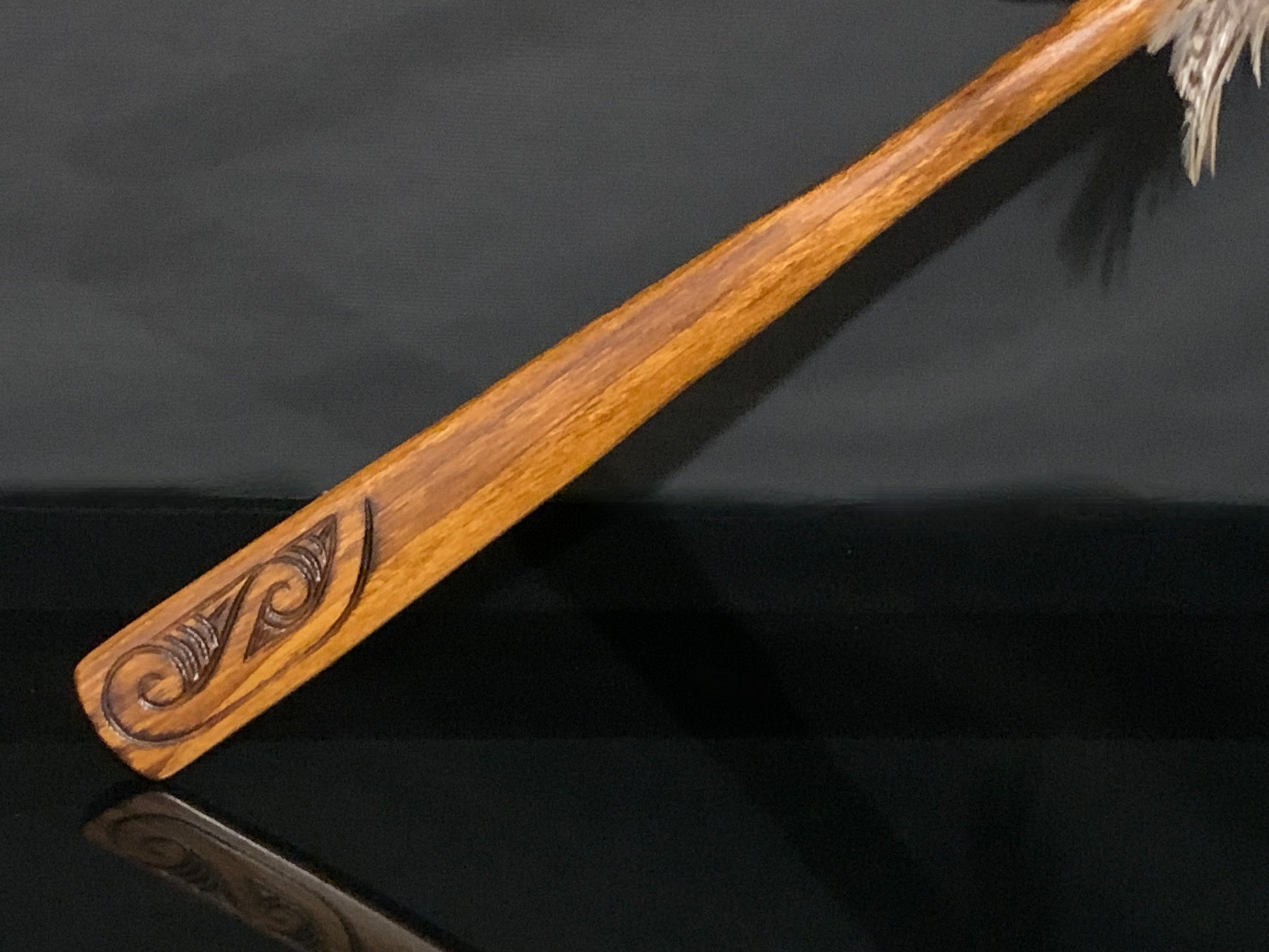 carving on handle from  taiaha weapon carved in New Zealand and available from Silver Fern Gallery