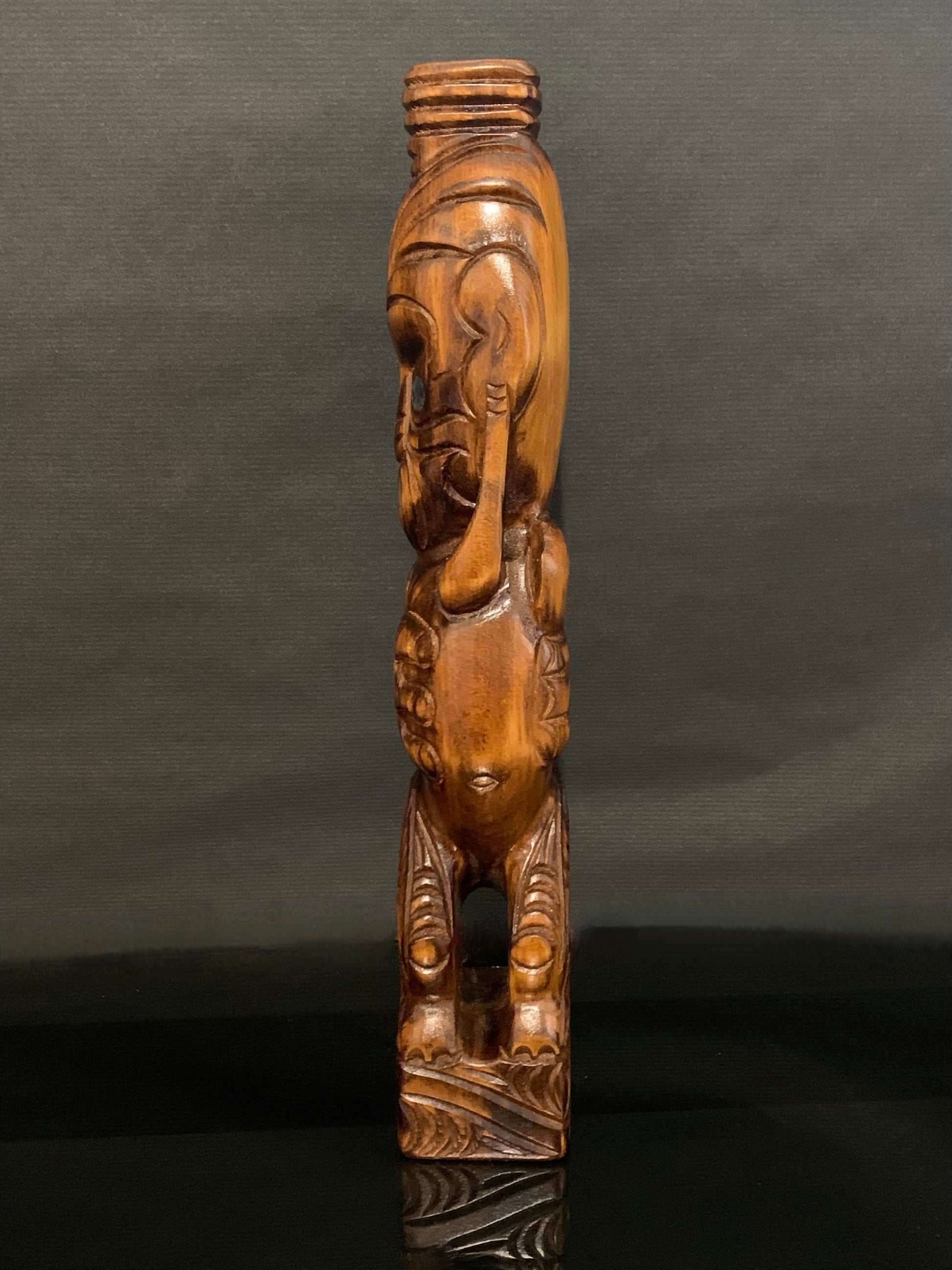 side view to the left of New Zealand Maori teko teko carved by Wood Masters Silver Fern Gallery