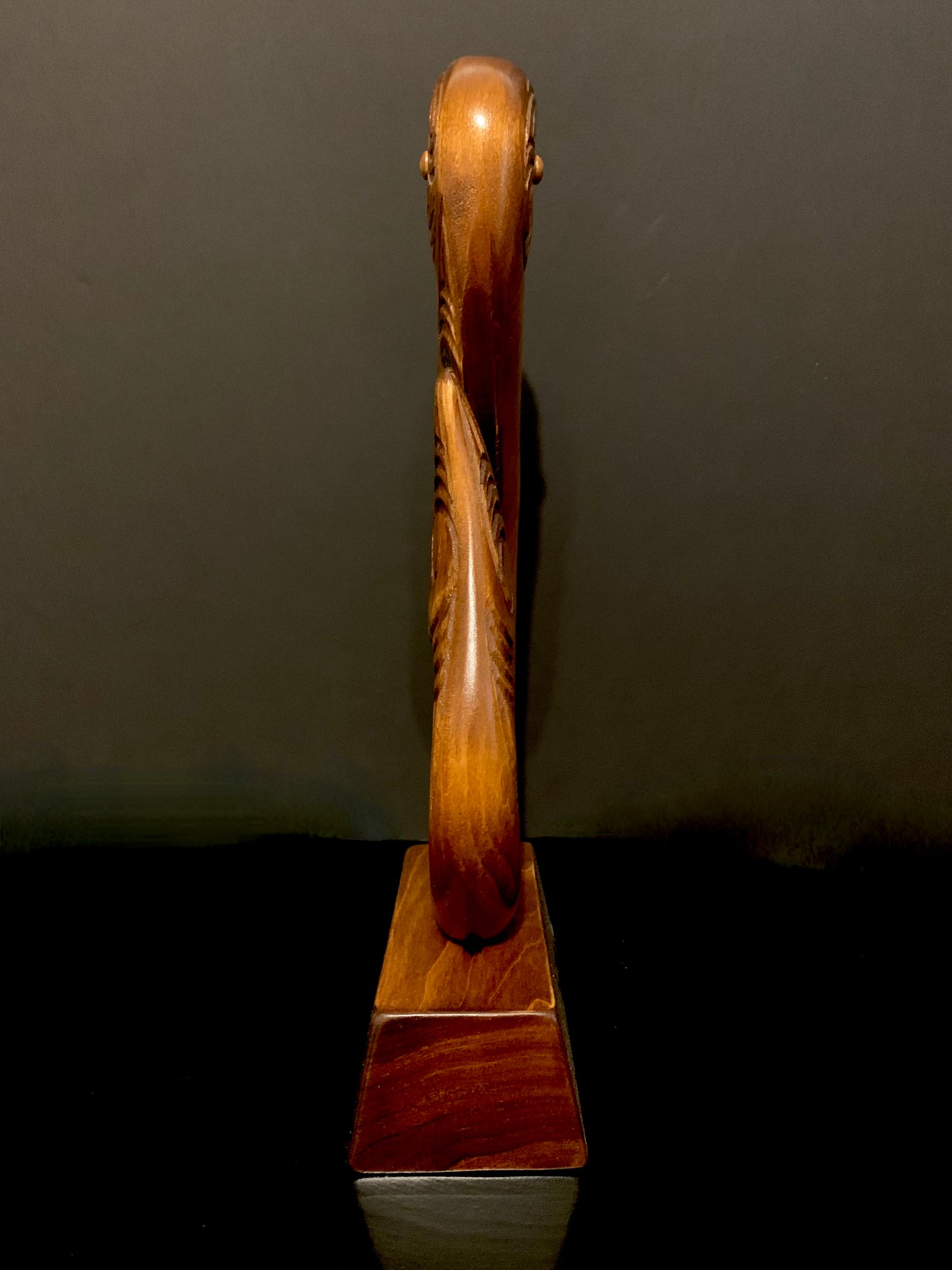 end view of matau fish hook on base by Wood Masters available from Silver Fern Gallery