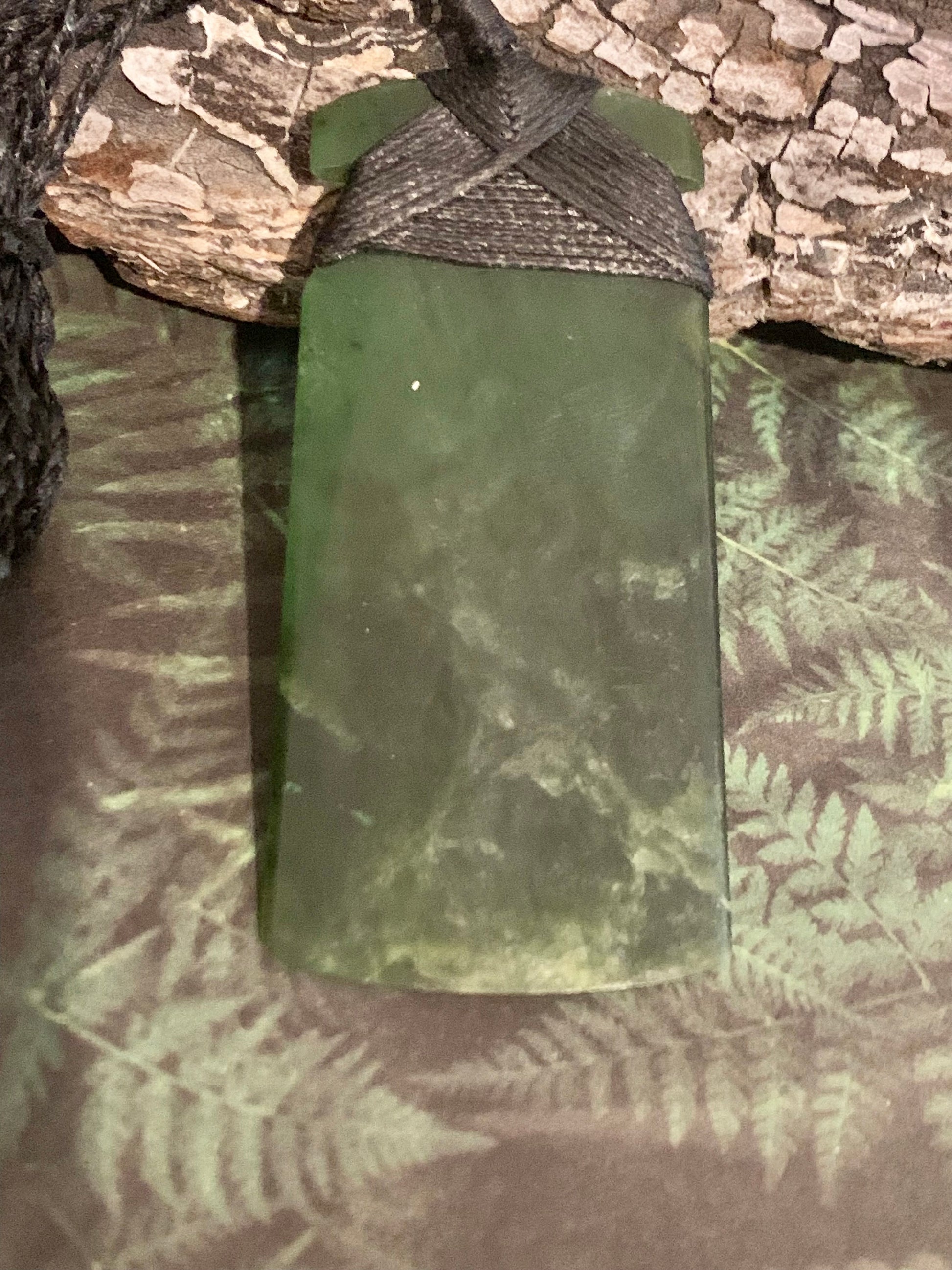 reverse view of Maori Pounamu hei toki pendant from New Zealand available at Silver Fern Gallery