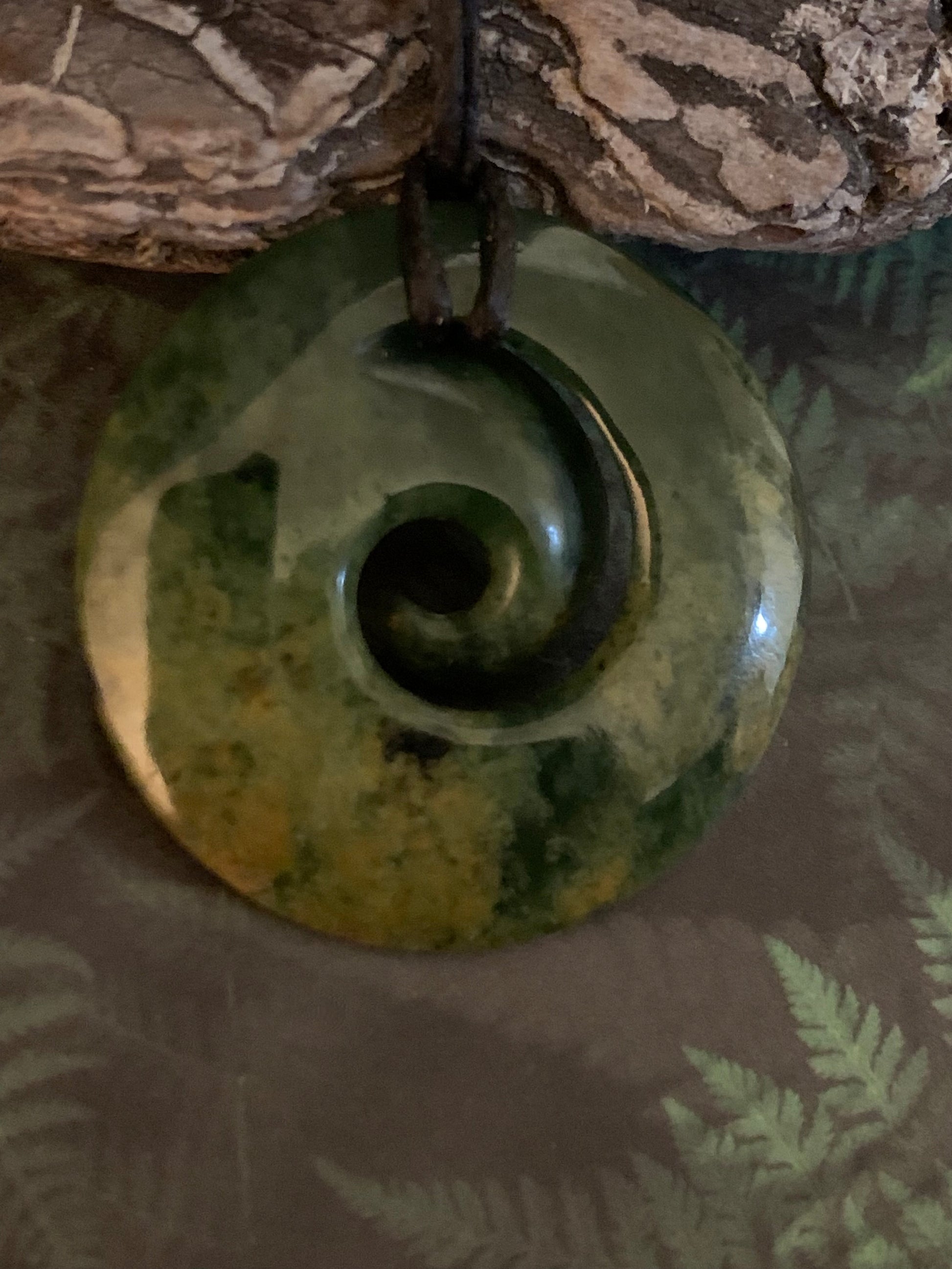 reverse side of Maori made Koru from New Zealand Pounamu greenstone jade