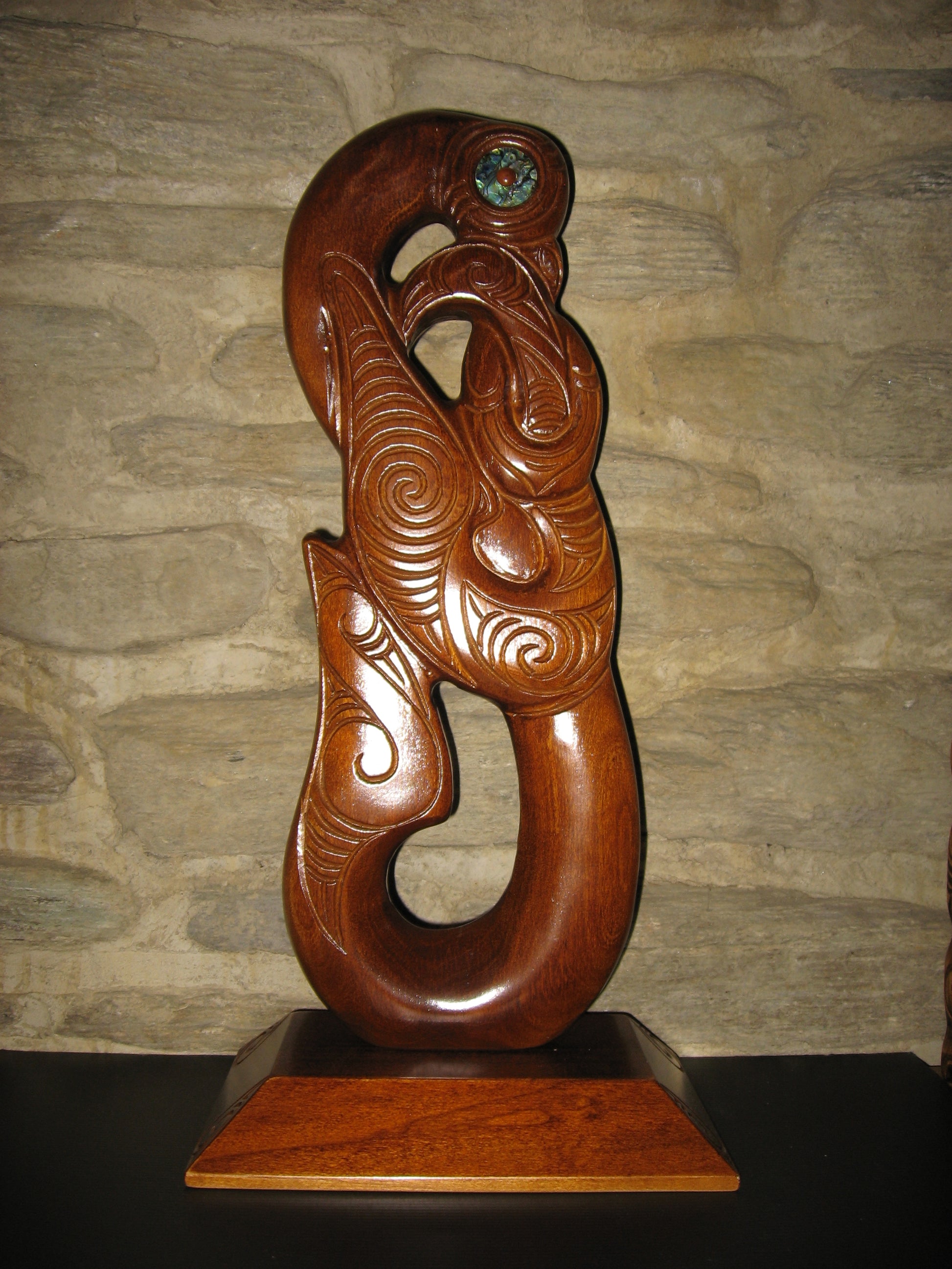 carved matau fish hook on base by Wood Masters available from Silver Fern Gallery