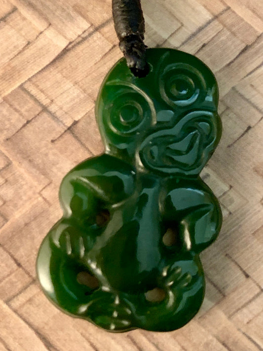 close up of New Zealand Maori Tiki pendant. Tiki is said to have held a wealth of knowledge and a great teacher of all things and the wearer would possess similar qualities