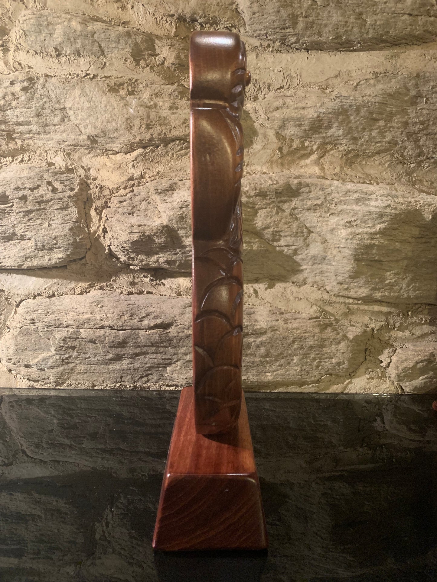 side view of Maori wood manaia on stand carved in New Zealand and available from Silver Fern Gallery