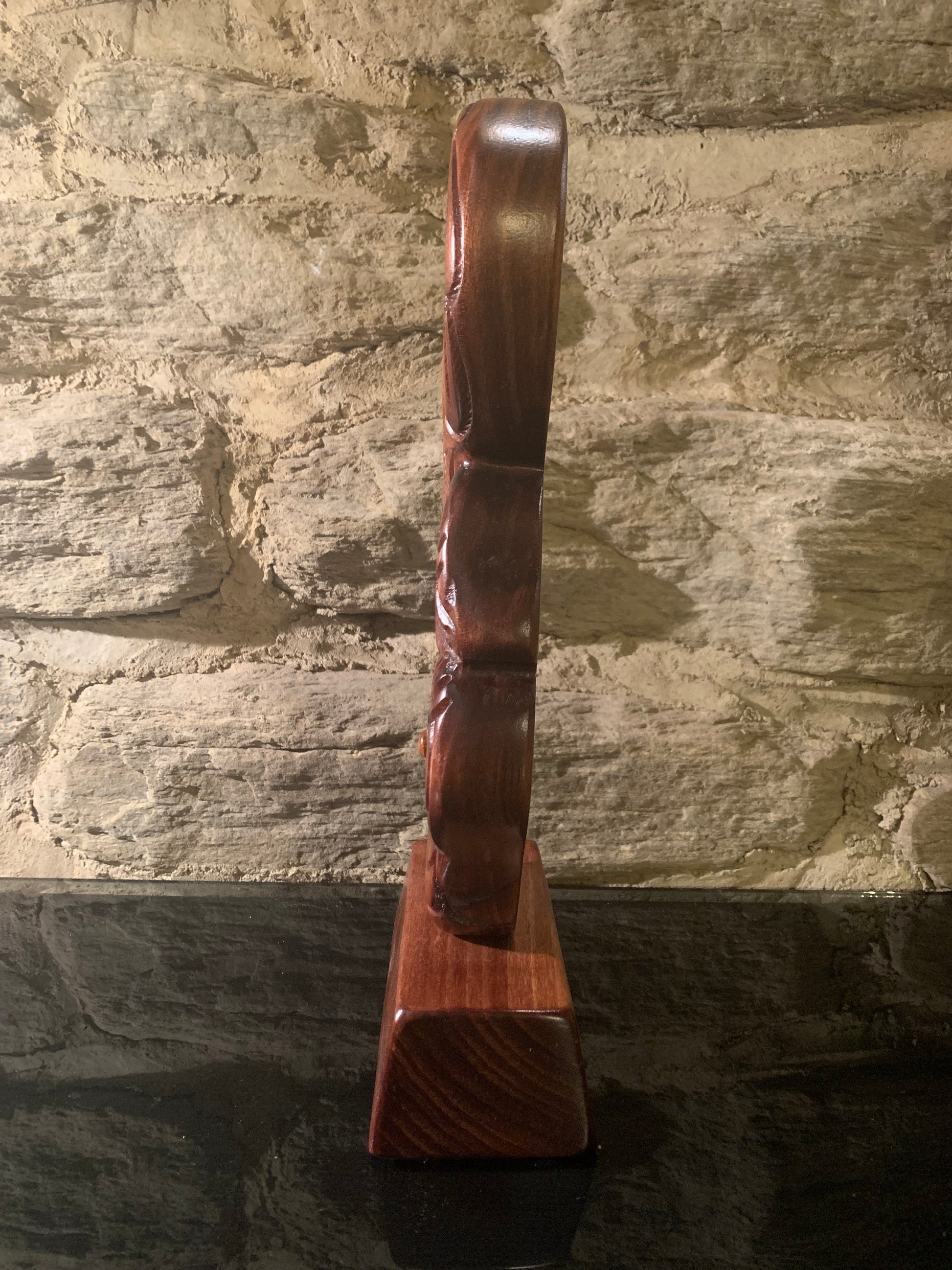 side view of Maori wood manaia on stand carved in New Zealand and available from Silver Fern Gallery