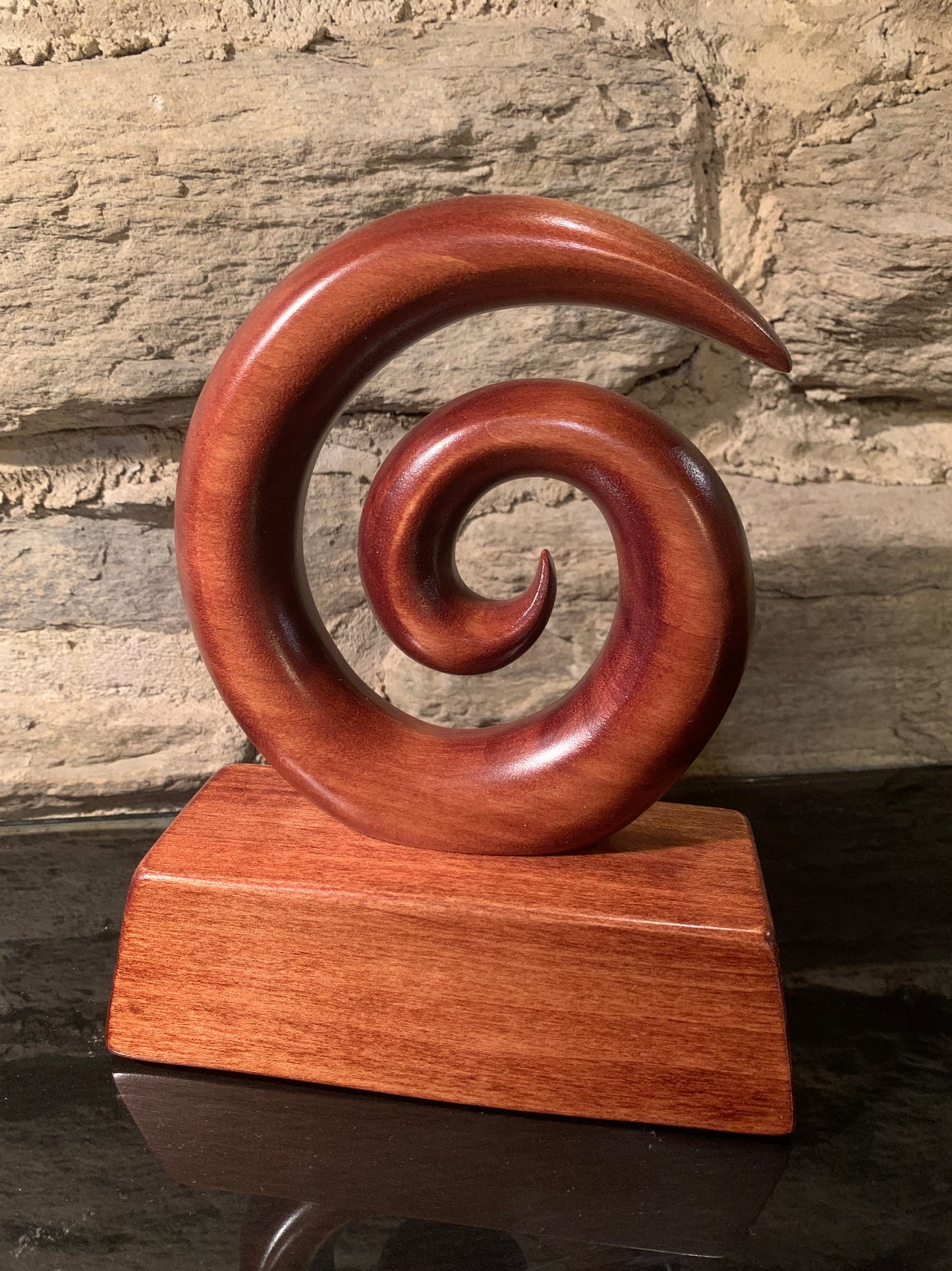 Maori small koru on stand carved in New Zealand and available from Silver Fern Gallery